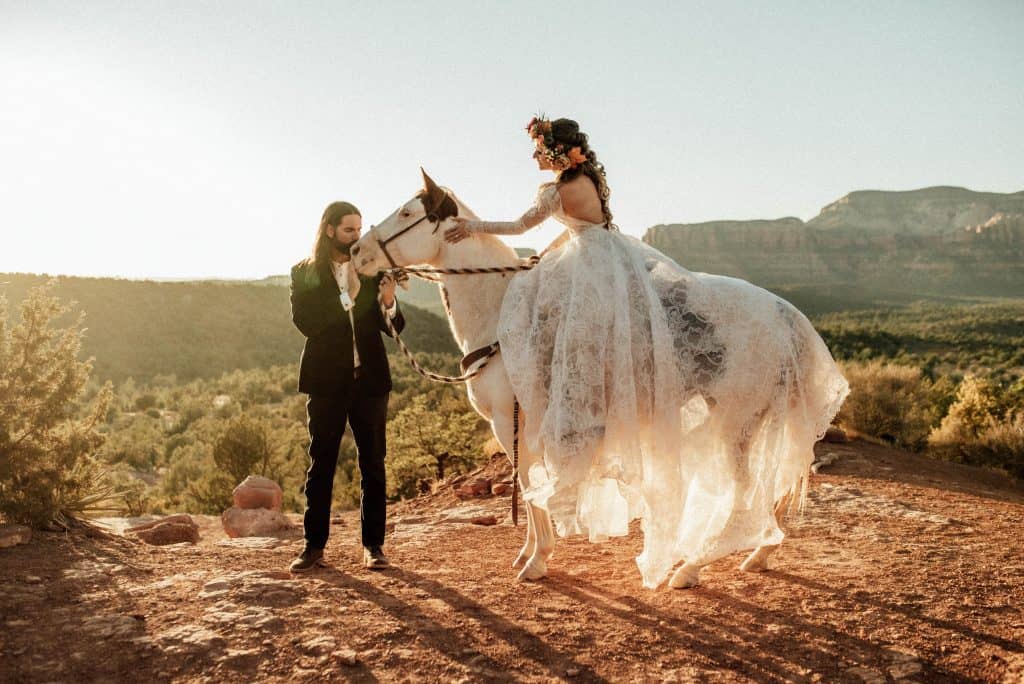 Bride and groom with a horse at their elopement in Sedona, Arizona