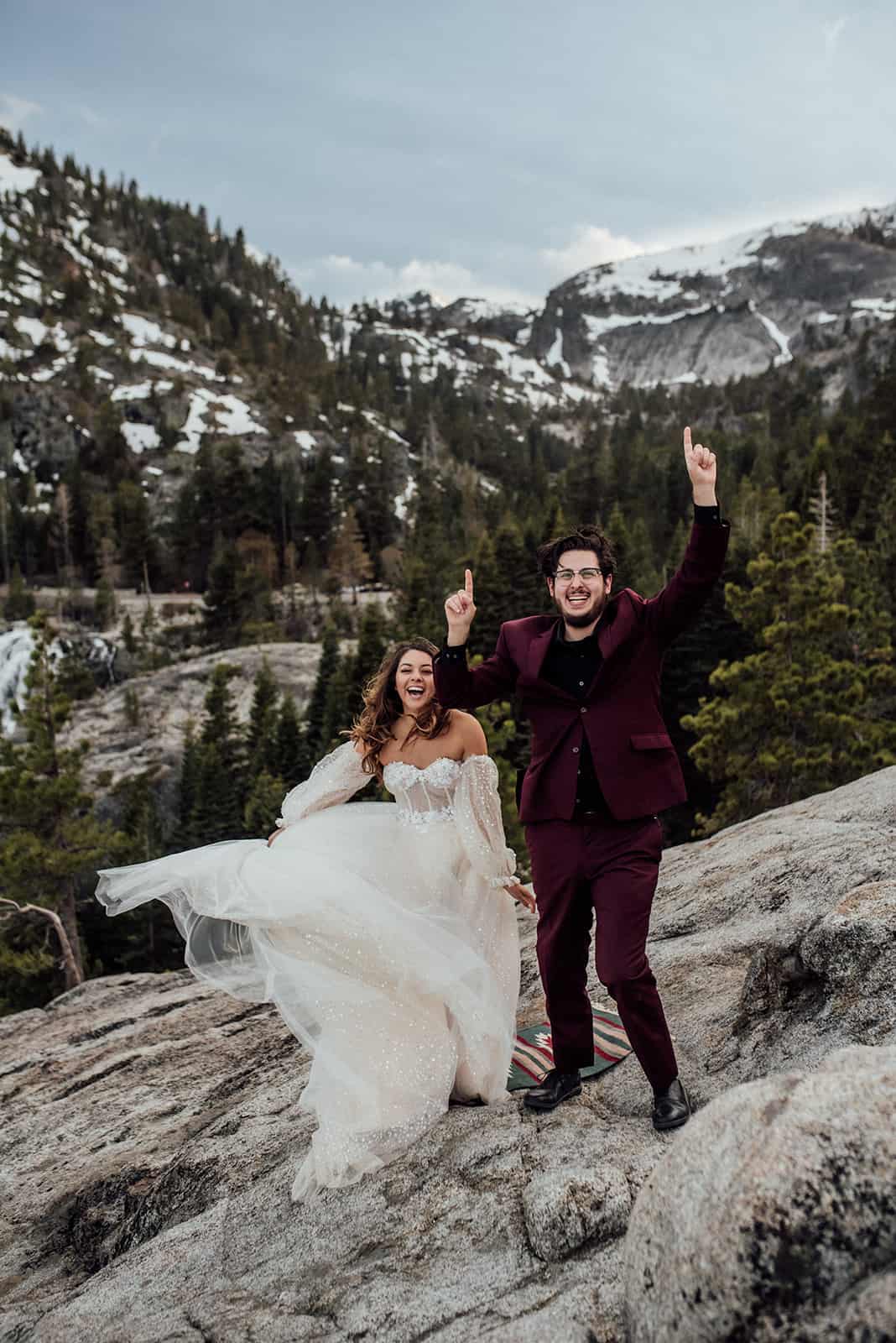 elopement couple dancing with snoy mountains behind